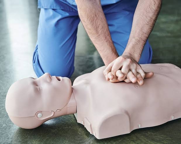 Chest compressions practiced on a CPR manikin