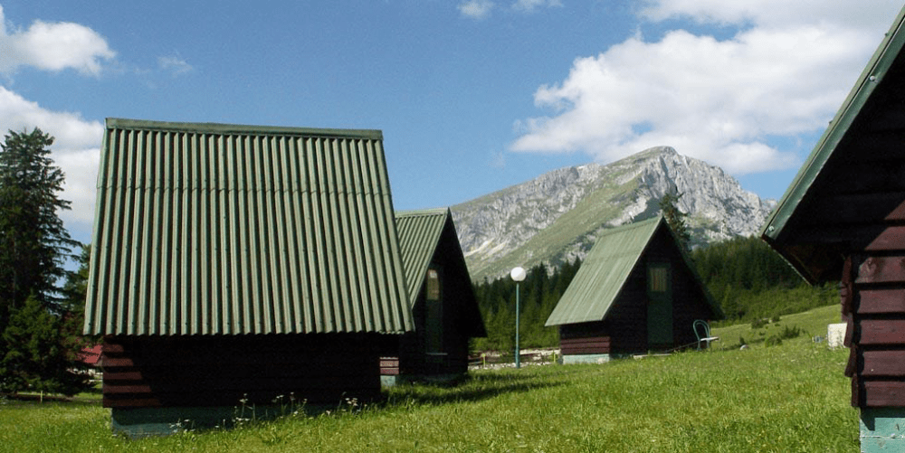 Wooden cabins beneath the Durmitor mountains