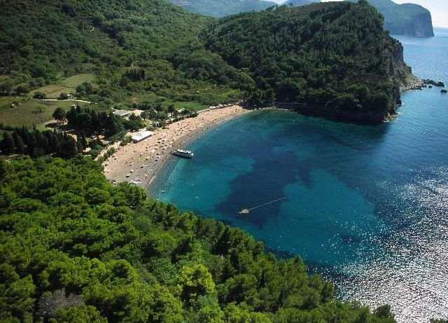 A sheltered beach surrounded by green hills